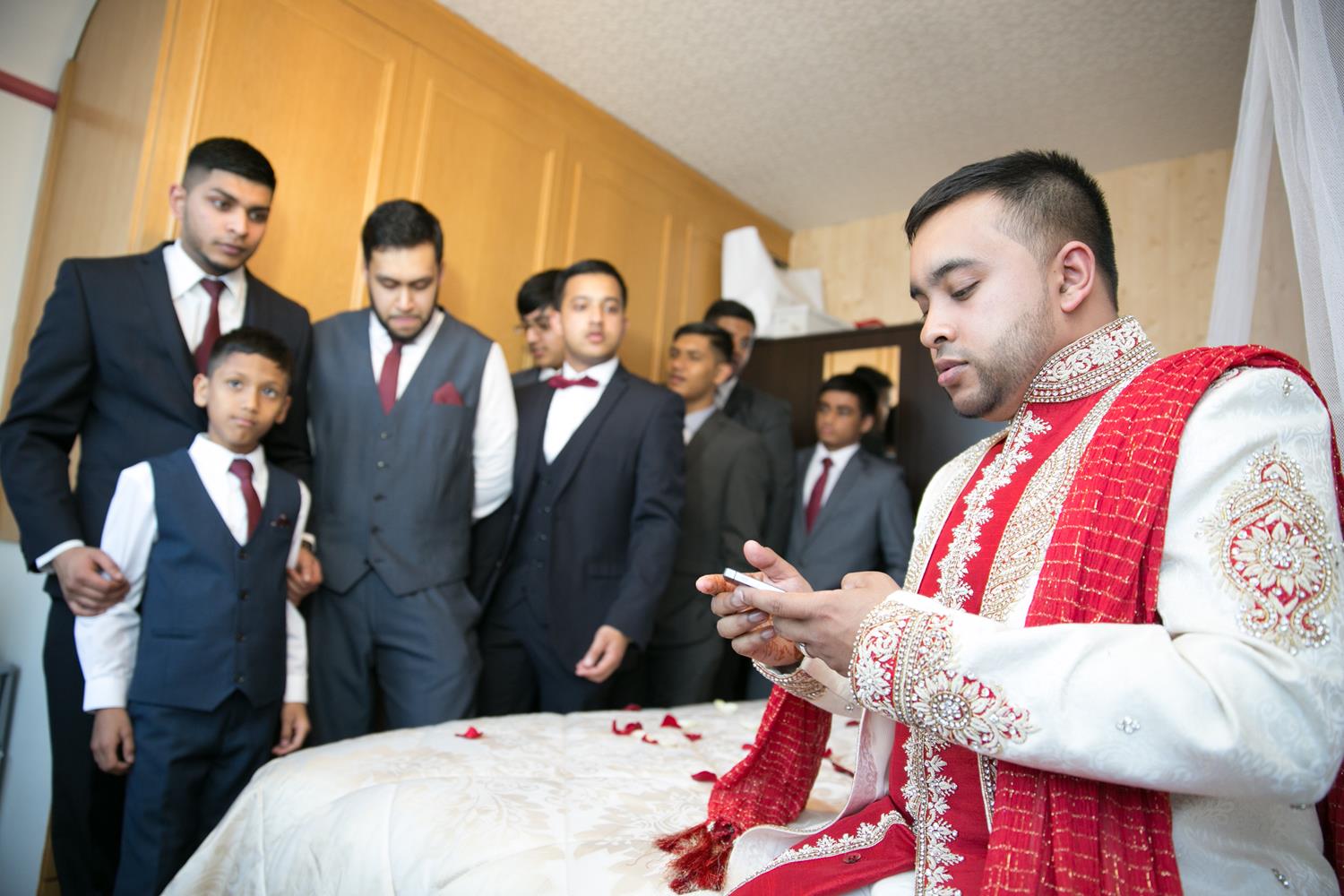 Wedding Photography of groom at home with brothers by MAKSAM Photography