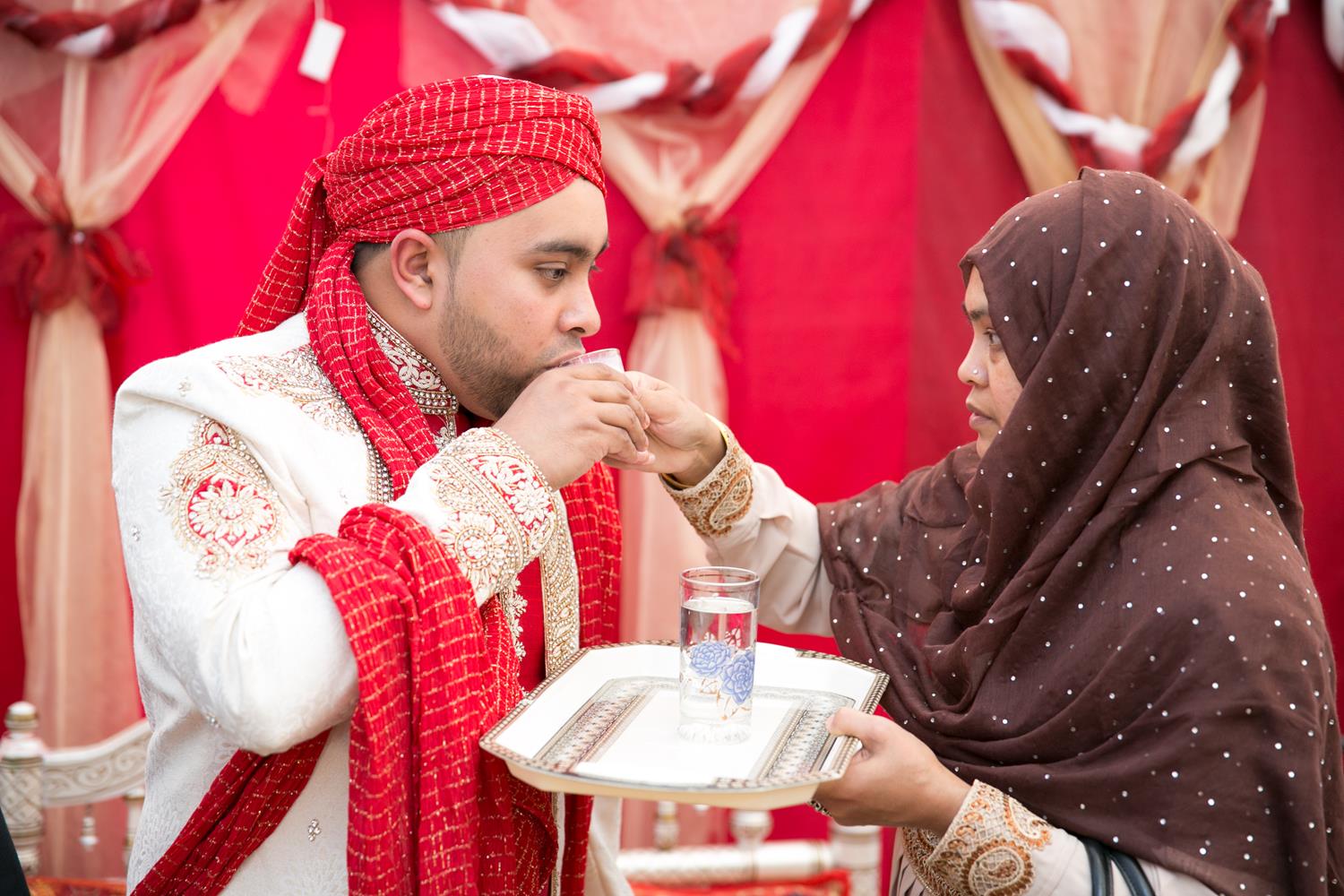 Wedding Photography of Bengali Groom drinking milk by MAKSAM Photography