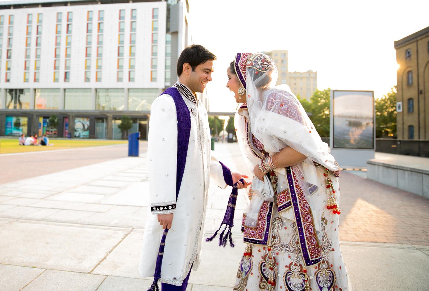 Wedding Photography of Bride and Groom laughing outside in London by MAKSAM Photography