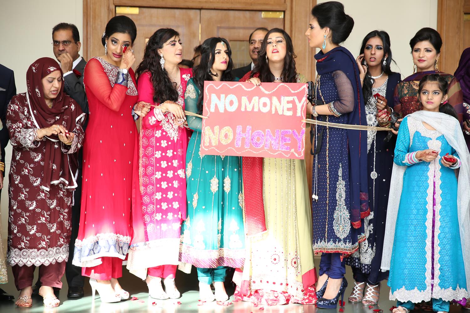 Wedding Photography of Asian money gate before grooms arrival by MAKSAM Photography London