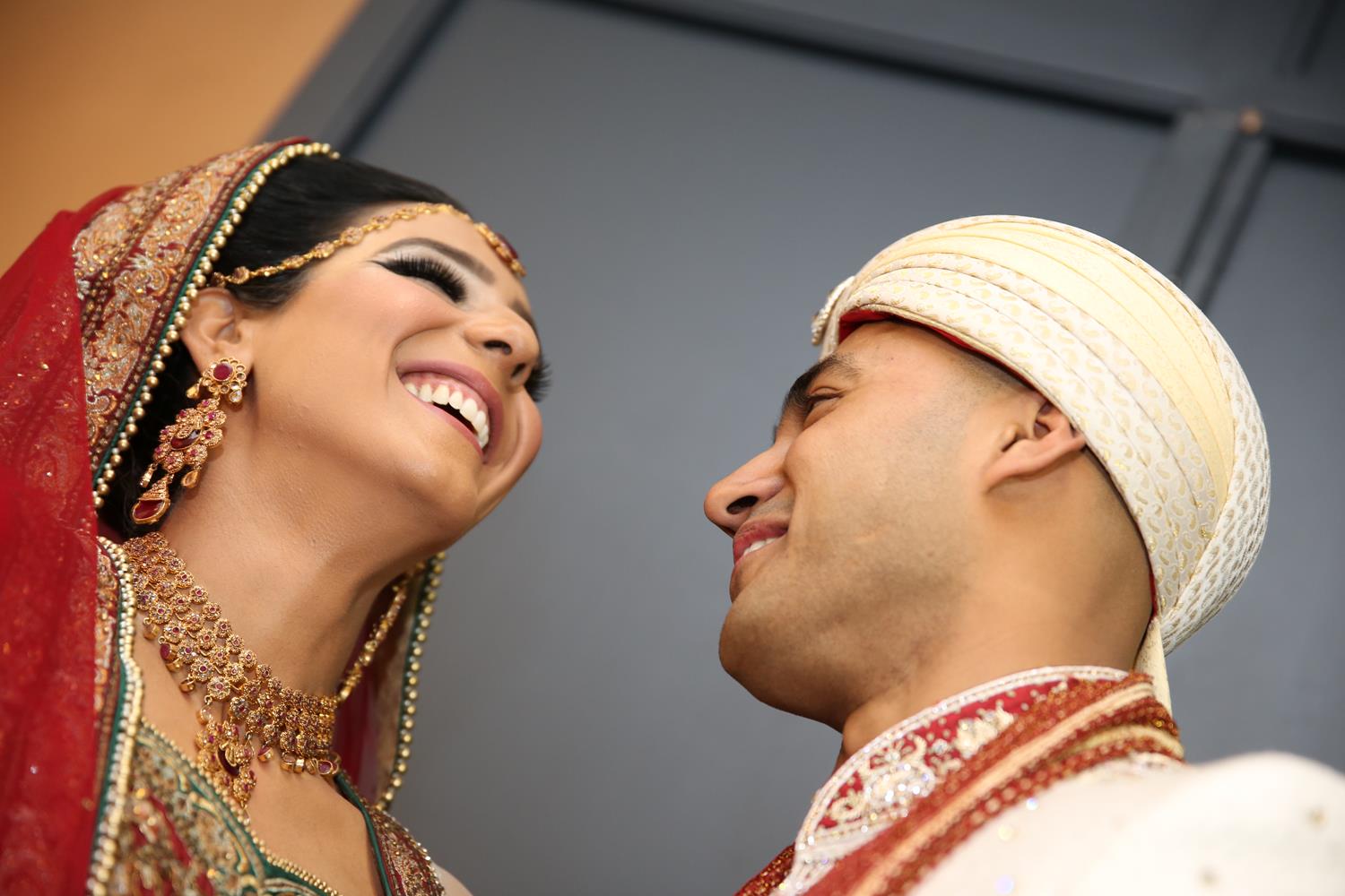 Wedding Photography of Bride and Groom laughing at their Asian Wedding by MAKSAM Photography London