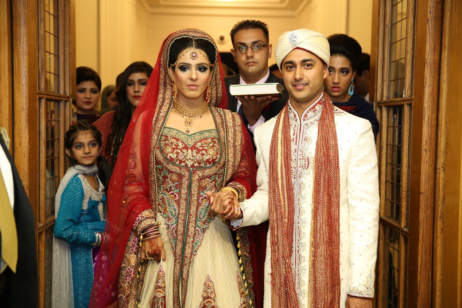 Wedding Photography of Pakistani Bride and Bengali Groom walking out at their Asian Wedding by MAKSAM Photography London