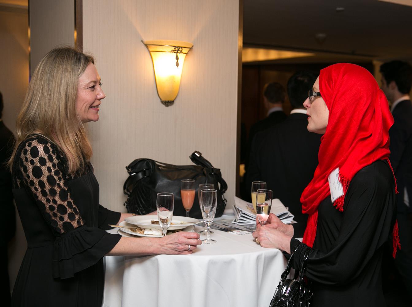 Corporate Photography of two business women in Hijab talking by MAKSAM London Photographer