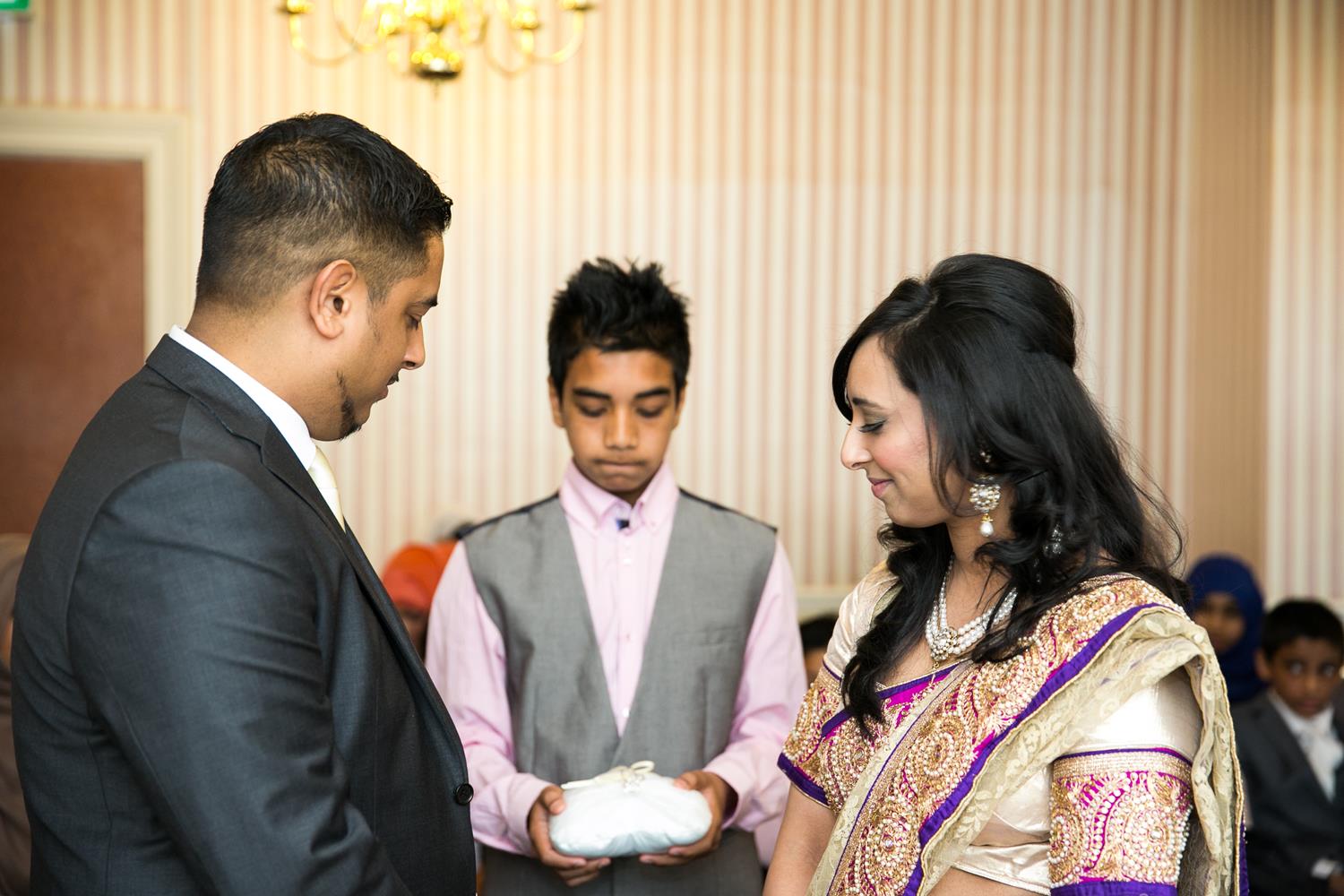 Registry Photography of couple receiving rings by MAKSAM Photography