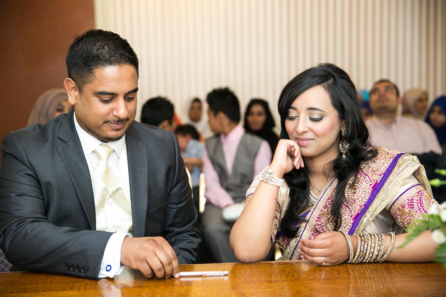 Registry Photography couple looking at pen by MAKSAM Photography