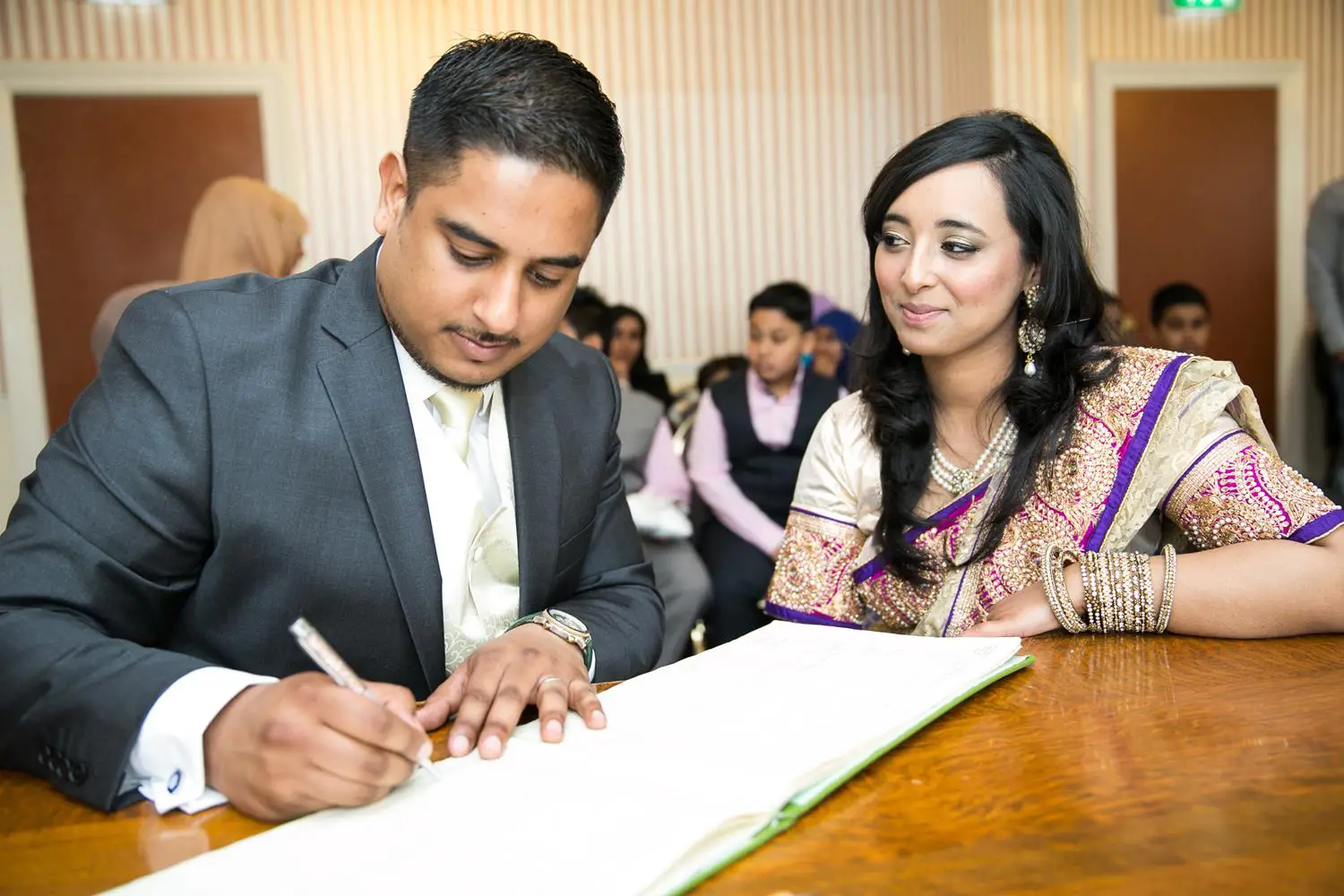 Registry Photography couple signing book by MAKSAM Photography