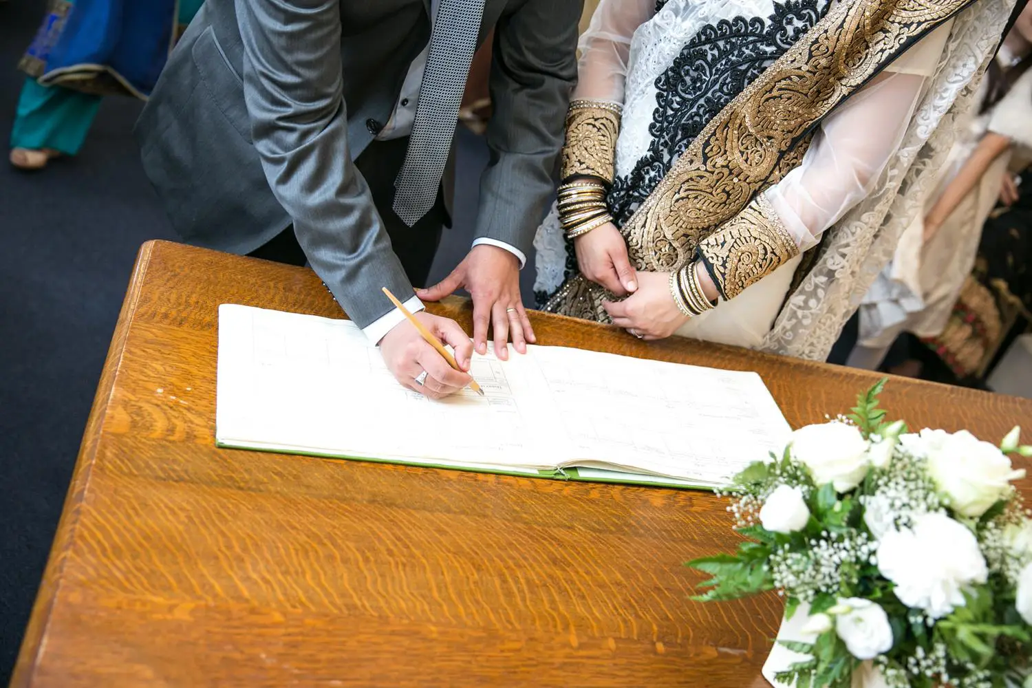 Registry Photography of couple signing book by MAKSAM Photography