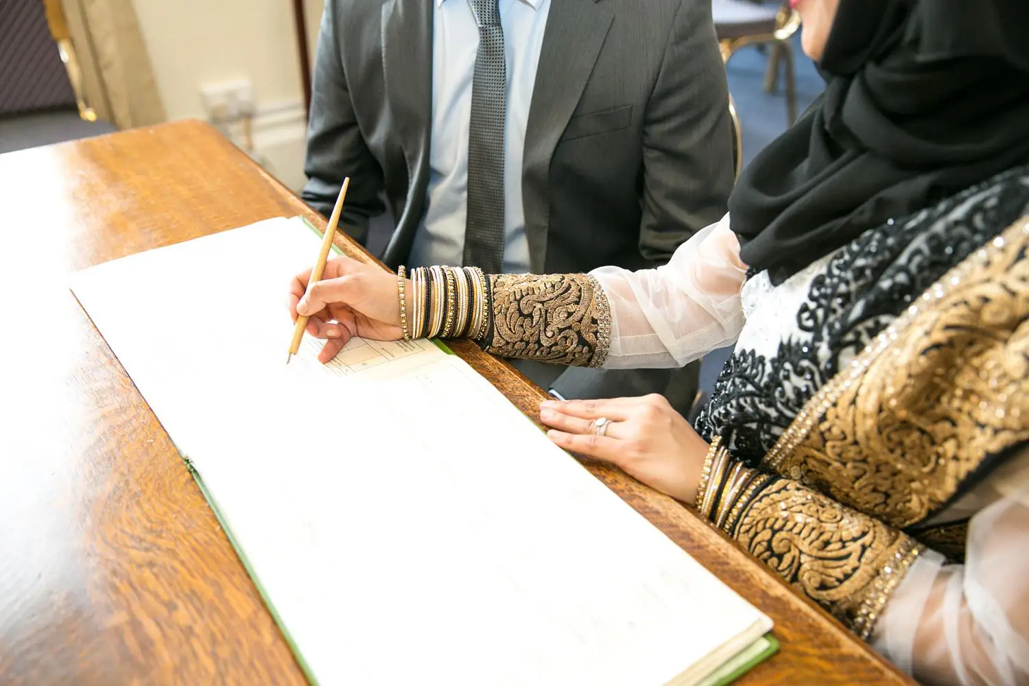 Registry Photography of couple signing book by MAKSAM Photography