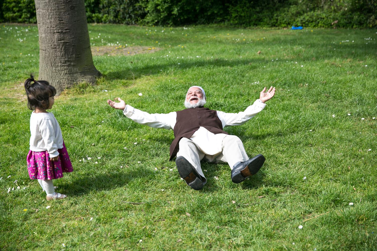 Muslim granddad on green grass by MAKSAM Photography