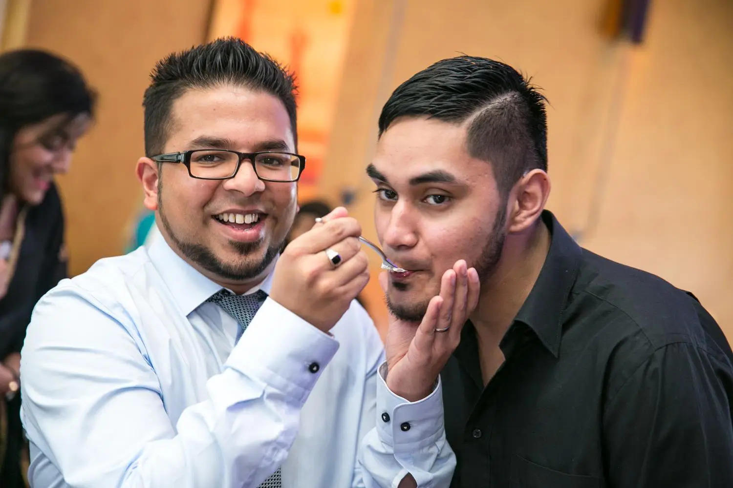 Indian Wedding Photography of Groom feeding family at his Asian Wedding by MAKSAM Photography