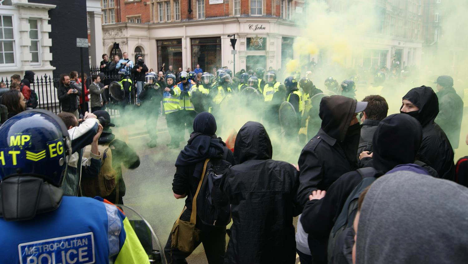 London police and smoke grenades charging at London Photographer by MAKSAM Photography