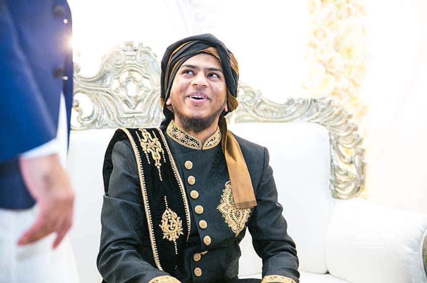 asian wedding groom smiling after