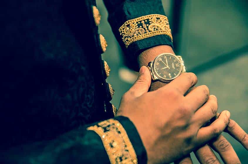 asian wedding groom watch after