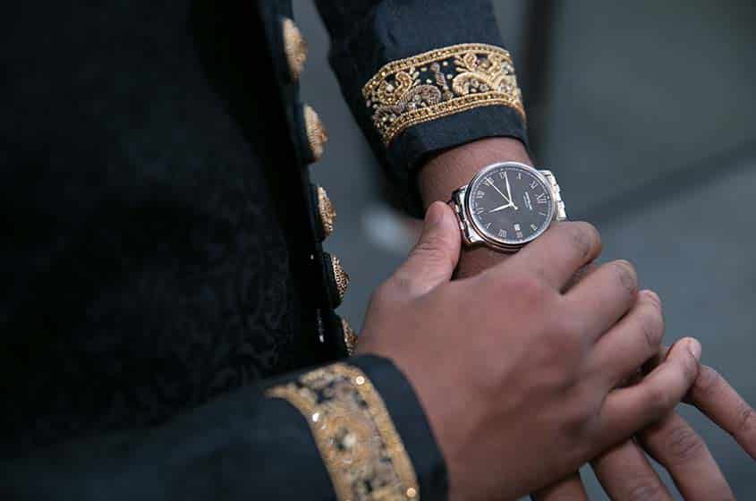 asian wedding groom watch before
